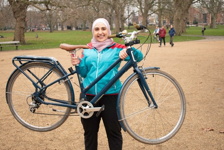 Woman holding up a bike